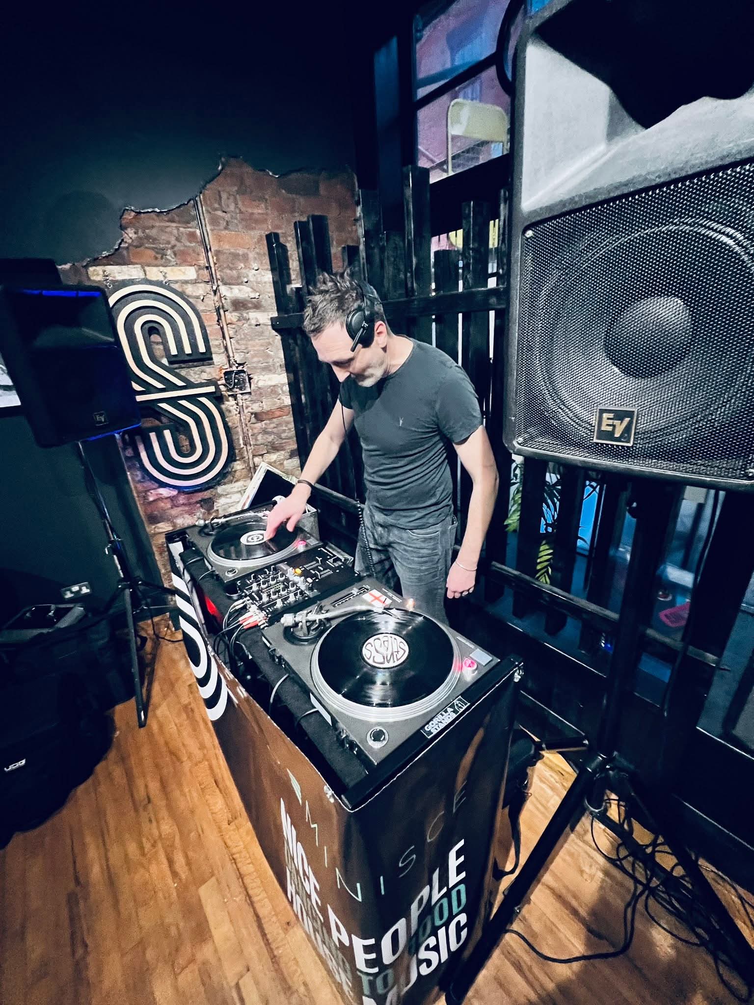 Nick Hopewell performing behind DJ decks