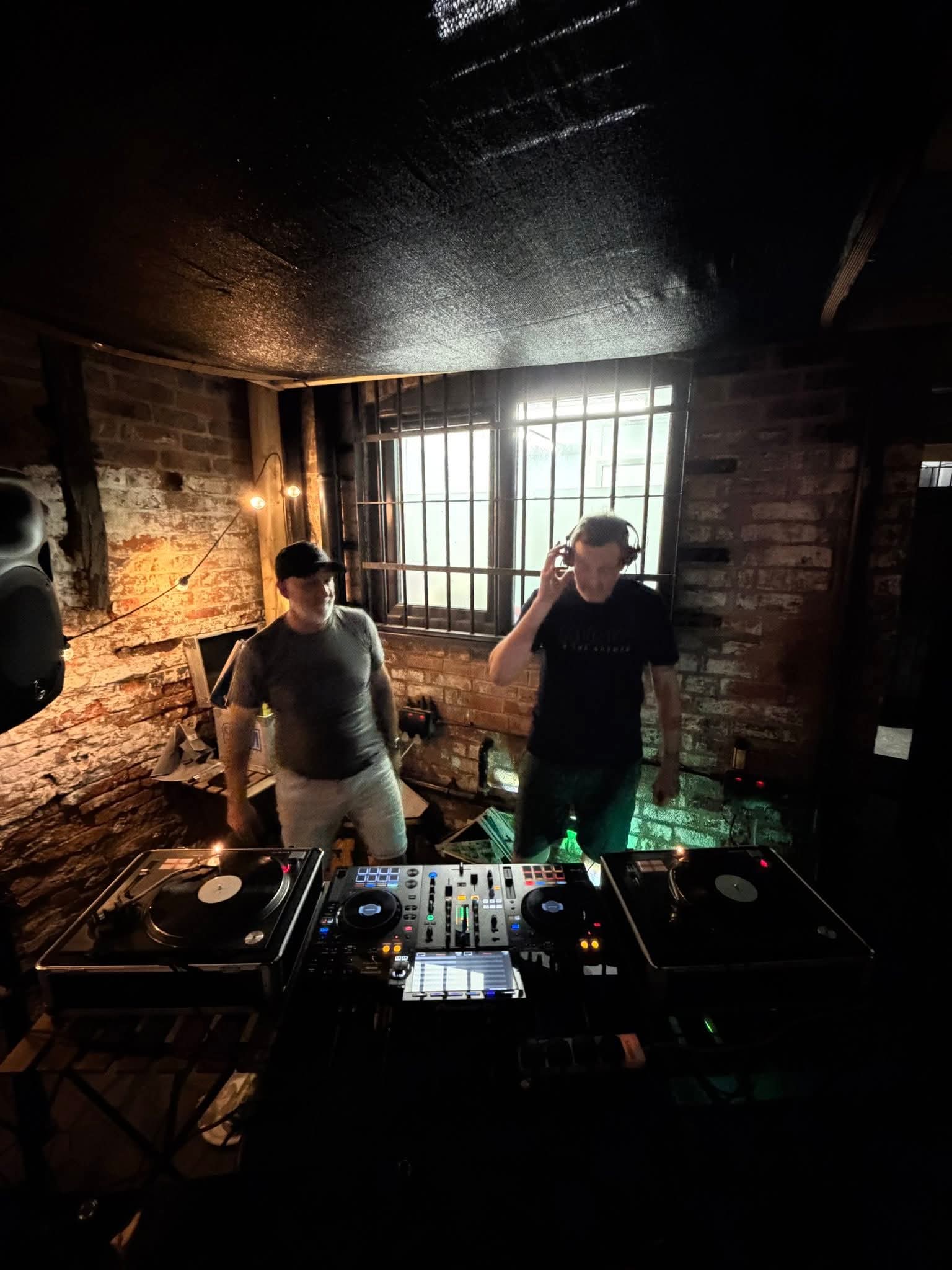 DJ booth in a rustic indoor venue